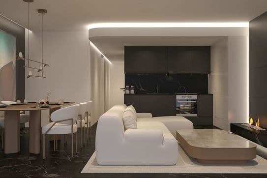 Modern open-plan living and dining room with white sofa, low coffee table, round dining table with white chairs, dark kitchen cabinets and linear fireplace