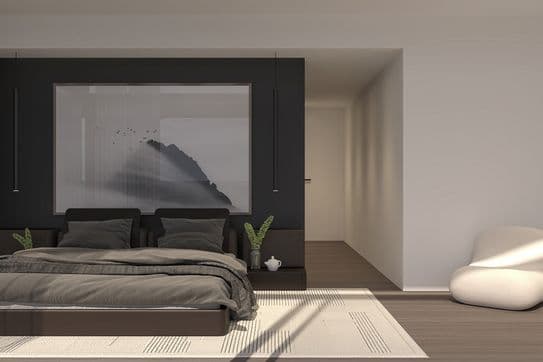Minimalist bedroom with low dark platform bed, gray linens, large misty mountain artwork on a black accent wall, pendant lights and cream lounge chairs.