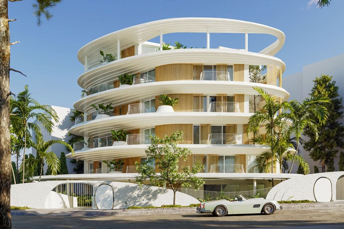 White circular modern apartment building with layered curved terraces, palm trees and a pale green vintage convertible parked in front.