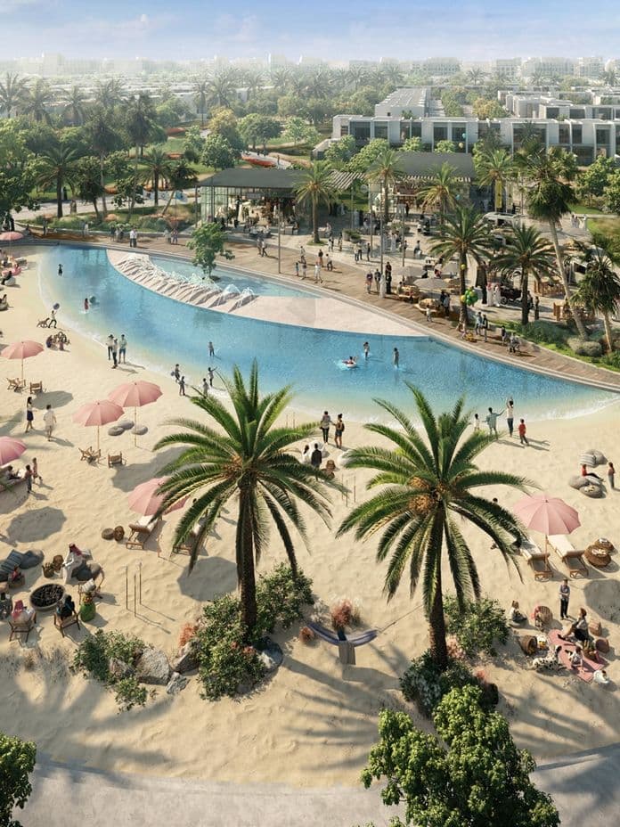 Aerial view of a tropical park with a large pool, palm trees, and people relaxing under pink umbrellas in a sunny urban setting.