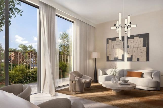Modern living room with a large window, white sofa, abstract art, and a chandelier. A rug and beige curtains add warmth. Garden view outside.