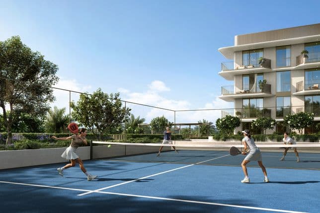 Residents playing tennis on an outdoor court at Sera 2, surrounded by landscaped gardens and contemporary apartment buildings.