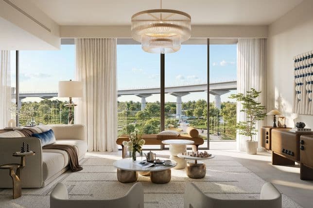 Spacious interior with floor-to-ceiling windows offering views of landscaped gardens and nearby metro bridge.