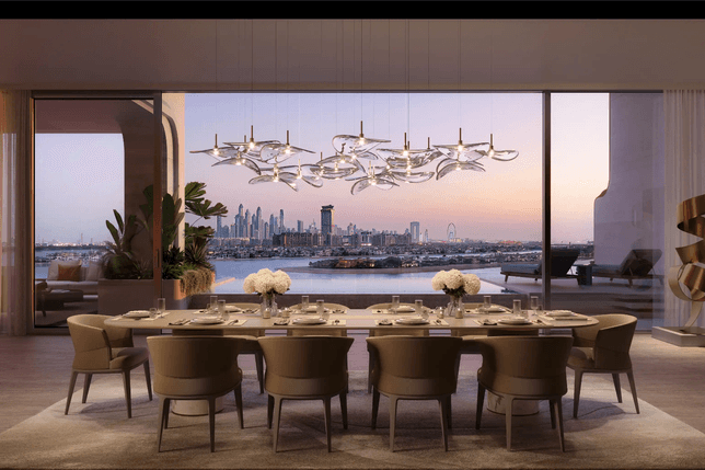 Elegant dining room with a long table set for a meal, overlooking a city skyline at sunset through large windows, featuring modern decor.
