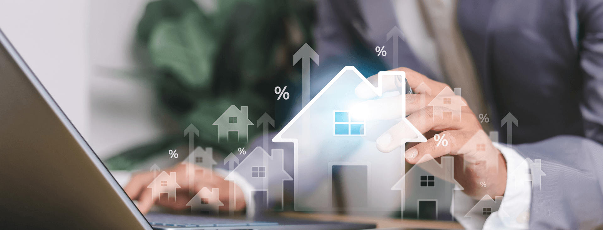A person in a suit using a laptop displaying holographic building logos and percentage signs, suggesting a real estate or investment concept.