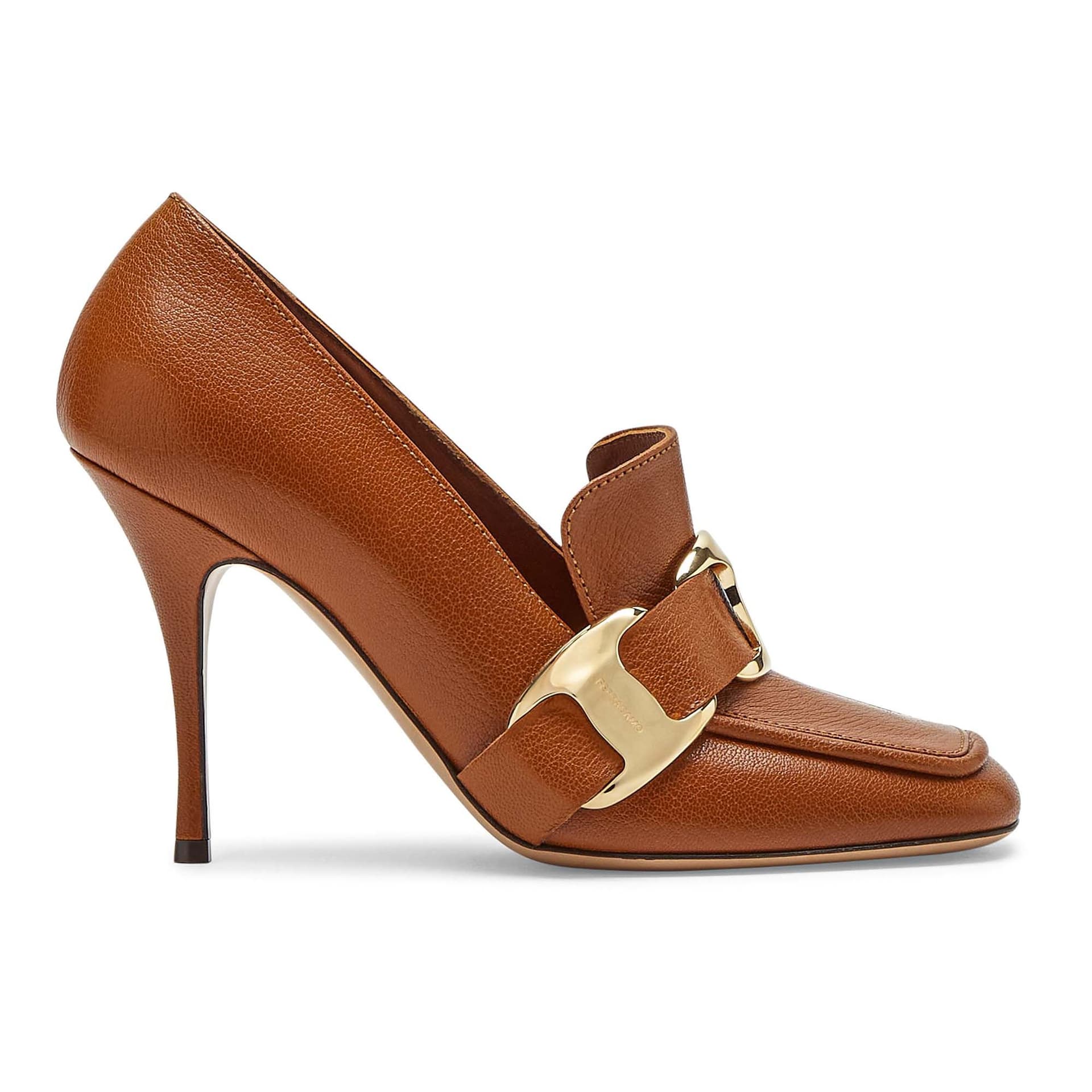 Brown leather shoe with heel, pointed toe and golden buckle decoration on the side.