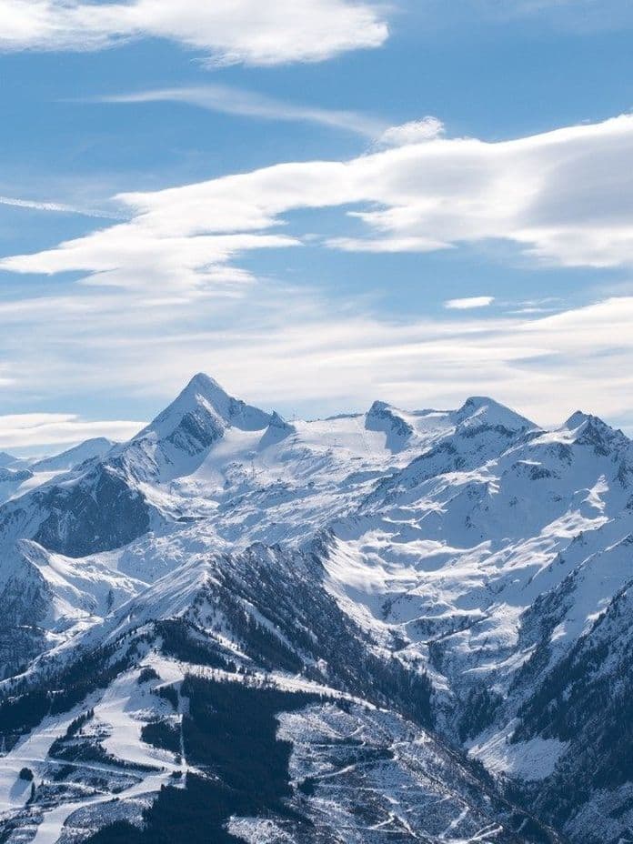 Snow-covered mountains of the Kitzsteinhorn with bright blue sky.