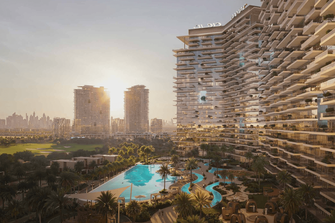 Modern high-rise buildings with balconies, overlooking a large swimming pool and lush gardens at sunset; city skyline in the background.