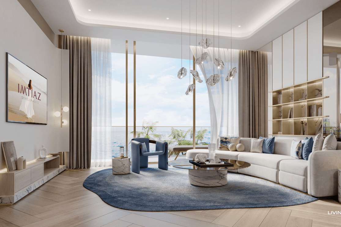 Living room at Sunset Bay 5 featuring a large sofa, built in shelving, floor to ceiling windows, and balcony views overlooking the waterfront.