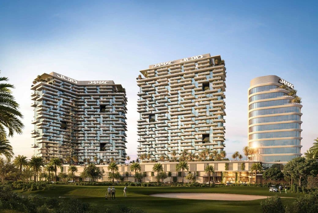 Three modern high-rise buildings with geometric facades, surrounded by palm trees and a golf course under a clear blue sky.