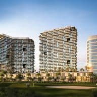 Three modern high-rise buildings with geometric facades, surrounded by palm trees and a golf course under a clear blue sky.