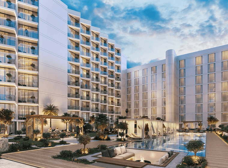 Gym at Playa Viva with modern equipment and large windows facing landscaped outdoor areas on Al Marjan Island.