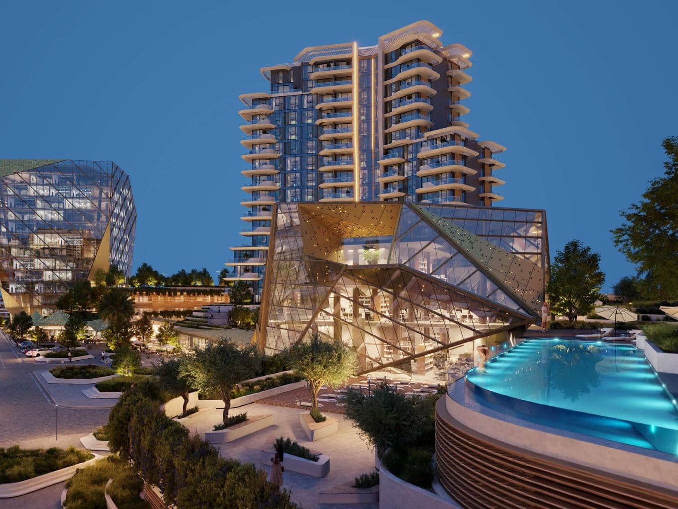 Modern urban complex with illuminated glass buildings and a rooftop infinity pool, surrounded by landscaped pathways and trees at dusk.