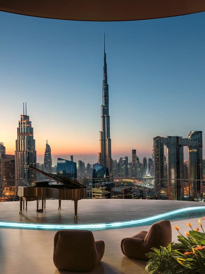 Luxurious rooftop with grand piano, plush seating, and plants overlooking a city skyline with the Burj Khalifa at sunset.