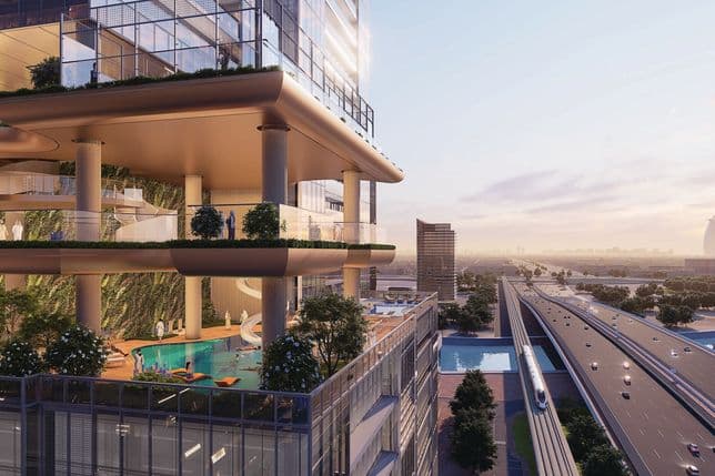 Modern multi-level building with greenery, pool, and glass facade overlooking a highway at sunset, with a cityscape in the background.