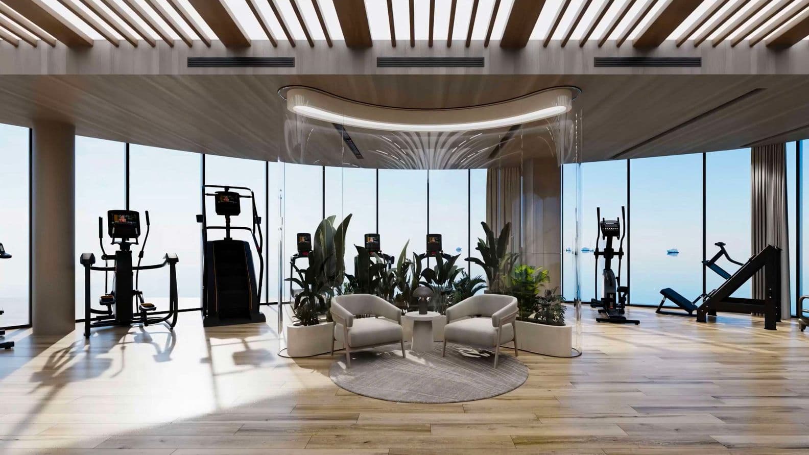Modern gym with exercise machines, seating area, and plants by large windows offering a scenic view. Wood flooring and ceiling accents.
