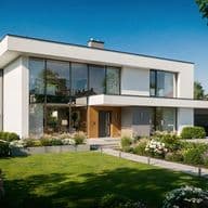 Modern two-story house with large glass windows, surrounded by a lush garden and lawn under a clear blue sky.