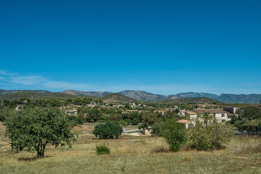 Panoramic view of the picturesque village of Establiments, Mallorca, surrounded by green hills and Mediterranean rural landscape