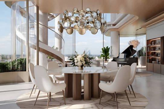 Modern dining area with a round table, white chairs, and a decorative chandelier. Spiral staircase and grand piano in the background.