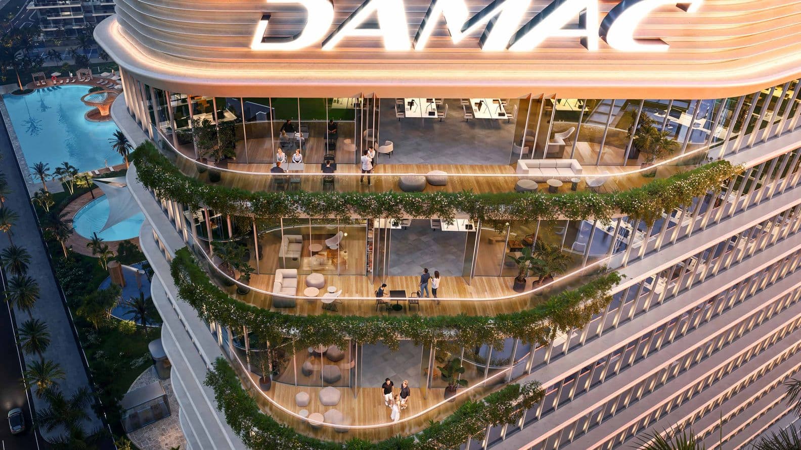 Rooftop view of a modern building with "DAMAC" signage, featuring terrace gardens, glass walls, and adjacent swimming pools at dusk.