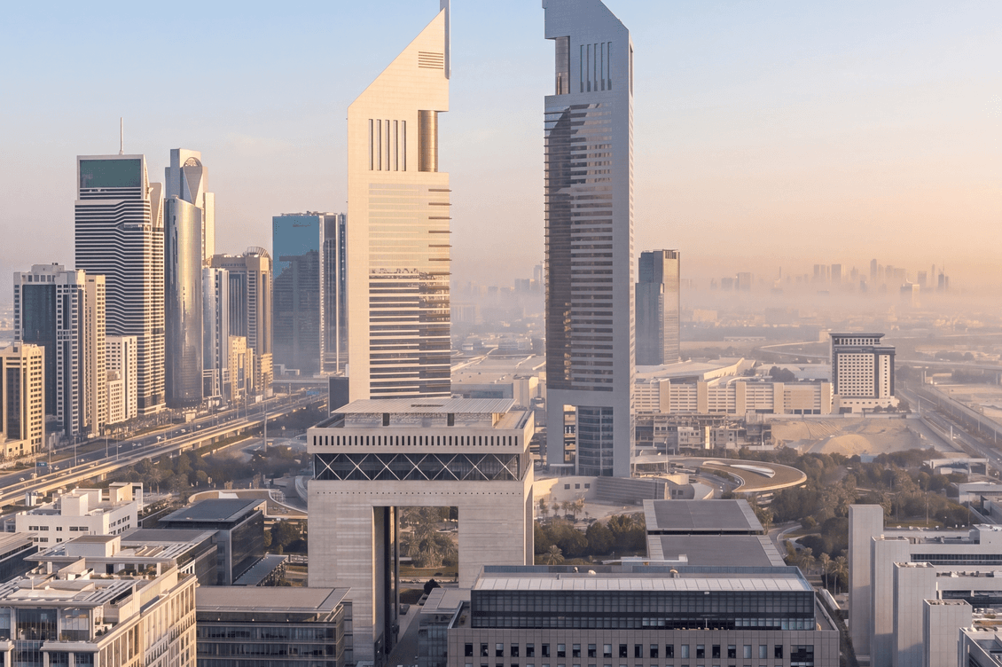 skyline image with two buildings highlighted in the sunset