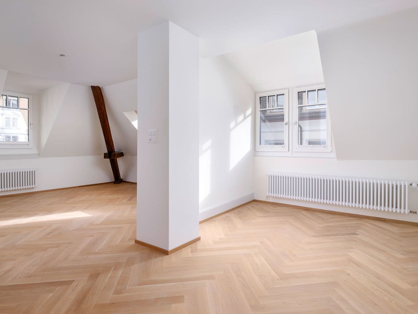 Großzügiges, modern eingerichtetes Wohnzimmer mit hellen Möbeln und einem Panoramablick auf Zürich