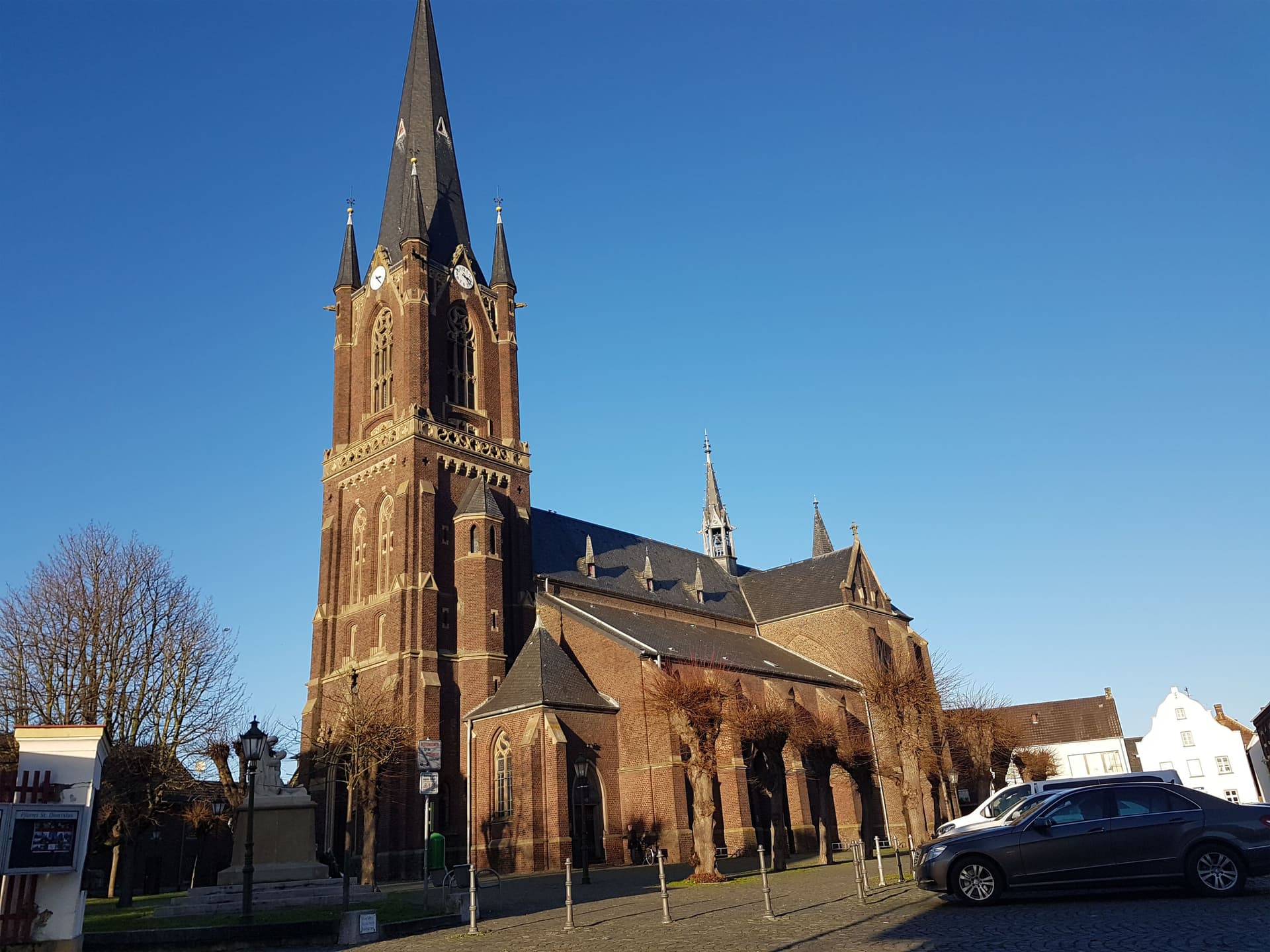 Historic neo-Gothic St. Dionysius Church in Kerken with tall tower and clear blue sky in North Rhine-Westphalia