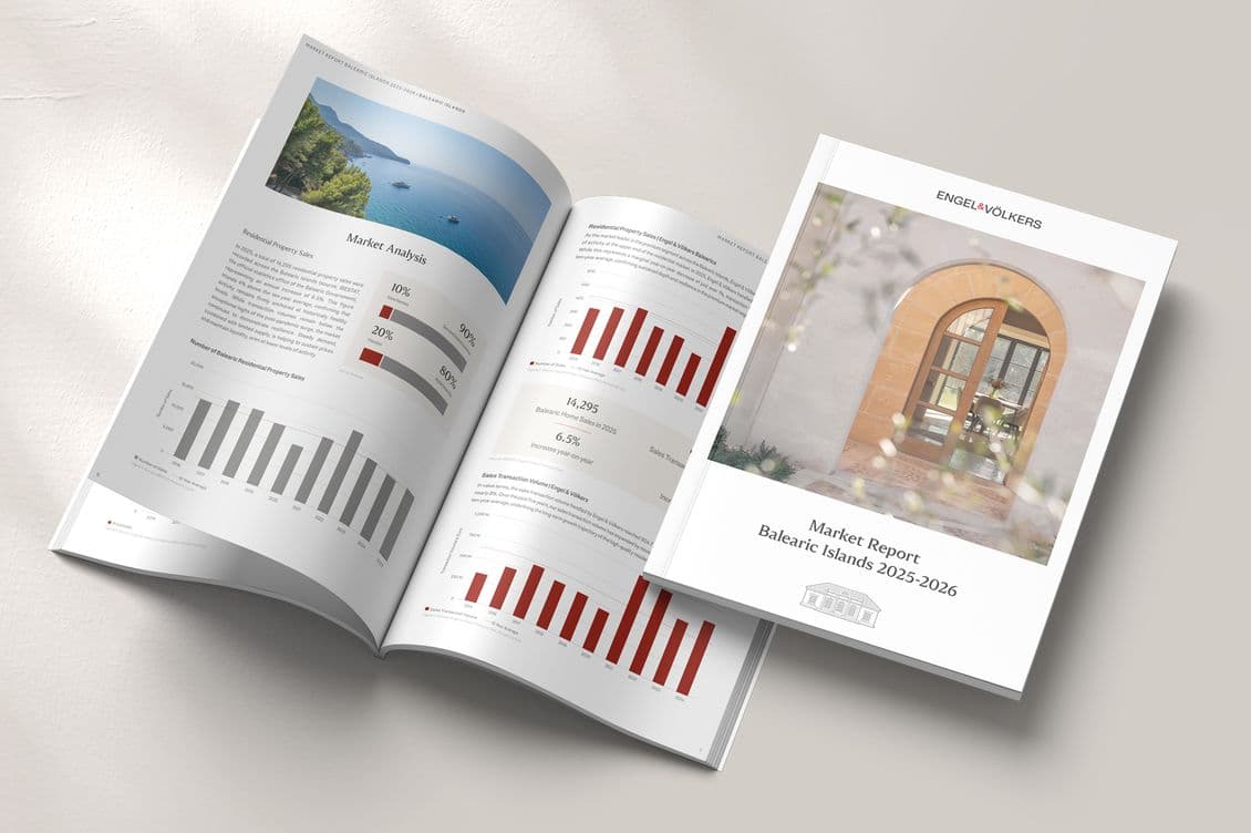 Open magazine with graphs and a photo by the sea; adjacent is a closed report titled "Market Report Balearic Islands 2025-2026."