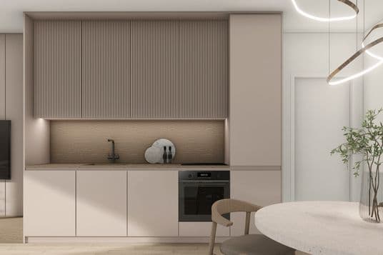 Modern kitchen area with built-in cabinets, wooden backsplash, black faucet, recessed lighting, and a round dining table nearby.