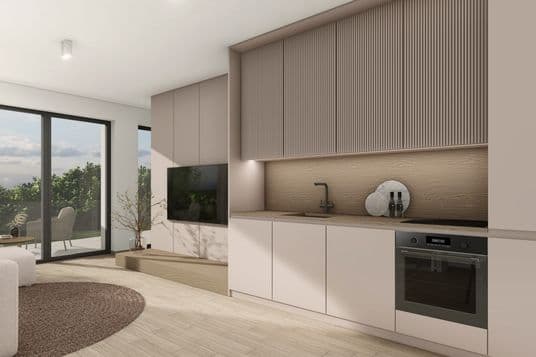 Modern kitchen with built-in cabinets, wooden backsplash, black faucet, oven, and a view through large glass doors onto a terrace with greenery.