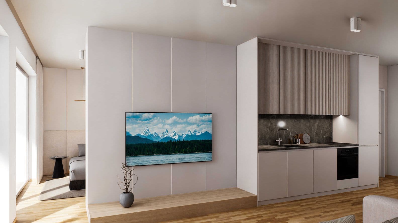 Modern apartment interior with a kitchenette, wall-mounted TV, sofa, and view into the bedroom, featuring light wood and neutral tones.