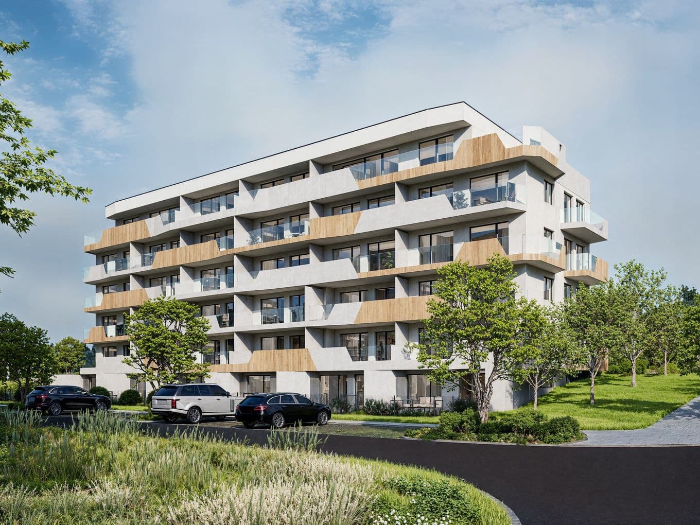 Modern residential building Terasy Sylván in Pilsen, five floors with balconies and terraces, surrounded by greenery and parked cars on the street in front.