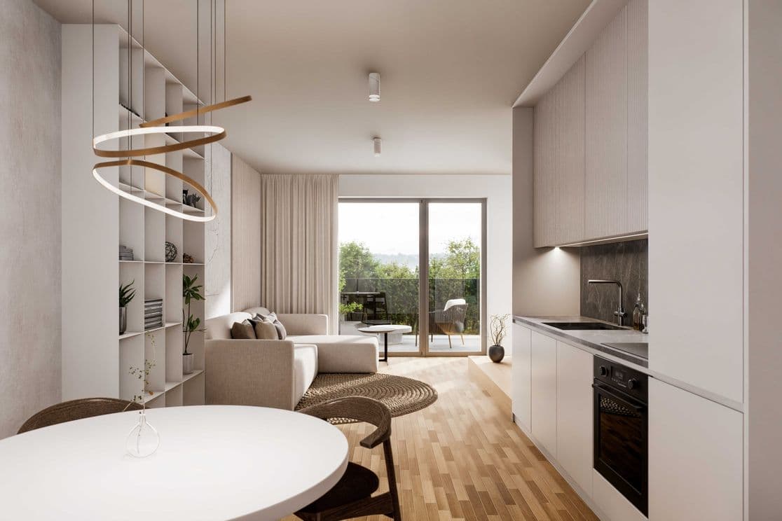 Bright modern living room with a kitchen, wooden floor, and large glass doors leading to a terrace with a view of greenery.