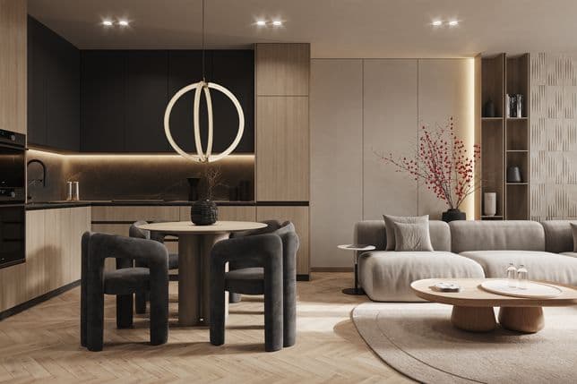 Modern apartment interior with a kitchen area in light wood finish, black cabinets, round dining table with four black chairs, comfortable beige sofa, and decorative elements including a vase with red branches.