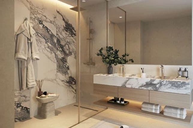Sophisticated bathroom design featuring a walk-in shower, dual vanity with marble finishes, recessed lighting, and minimalistic high-end fixtures.