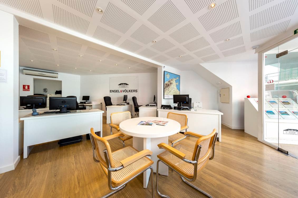 Interior view of the Engel & Völkers property shop in Puerto Pollença, showcasing a modern and stylish space with professional displays