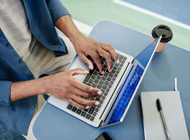 man registers the Ejari for his Dubai rental property using his laptop