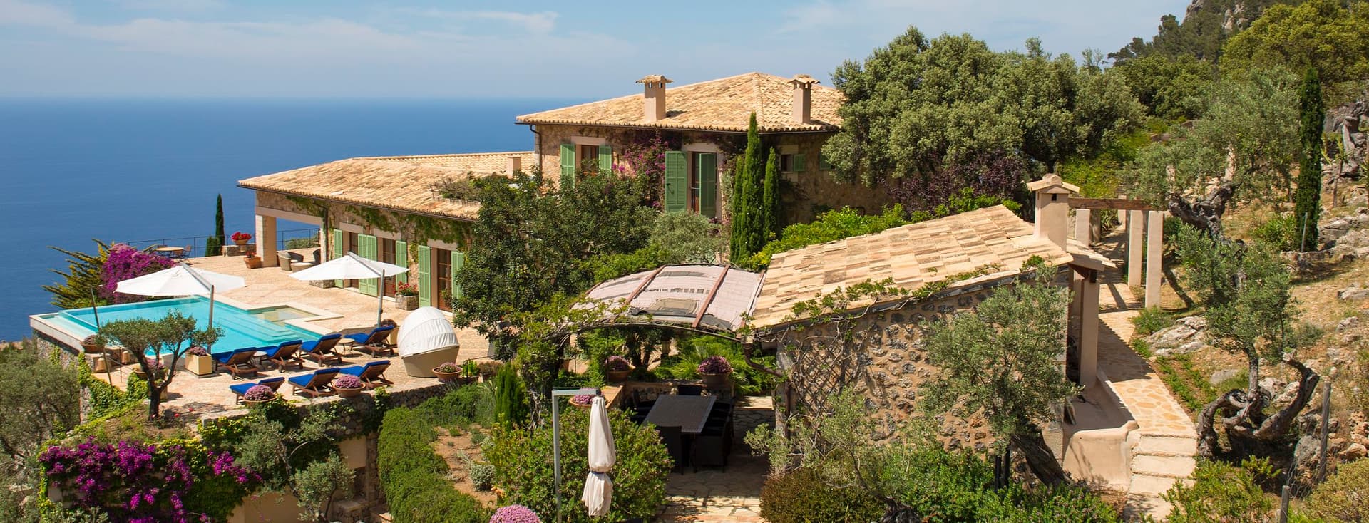 Villa mediterránea con piscina y vistas al mar.