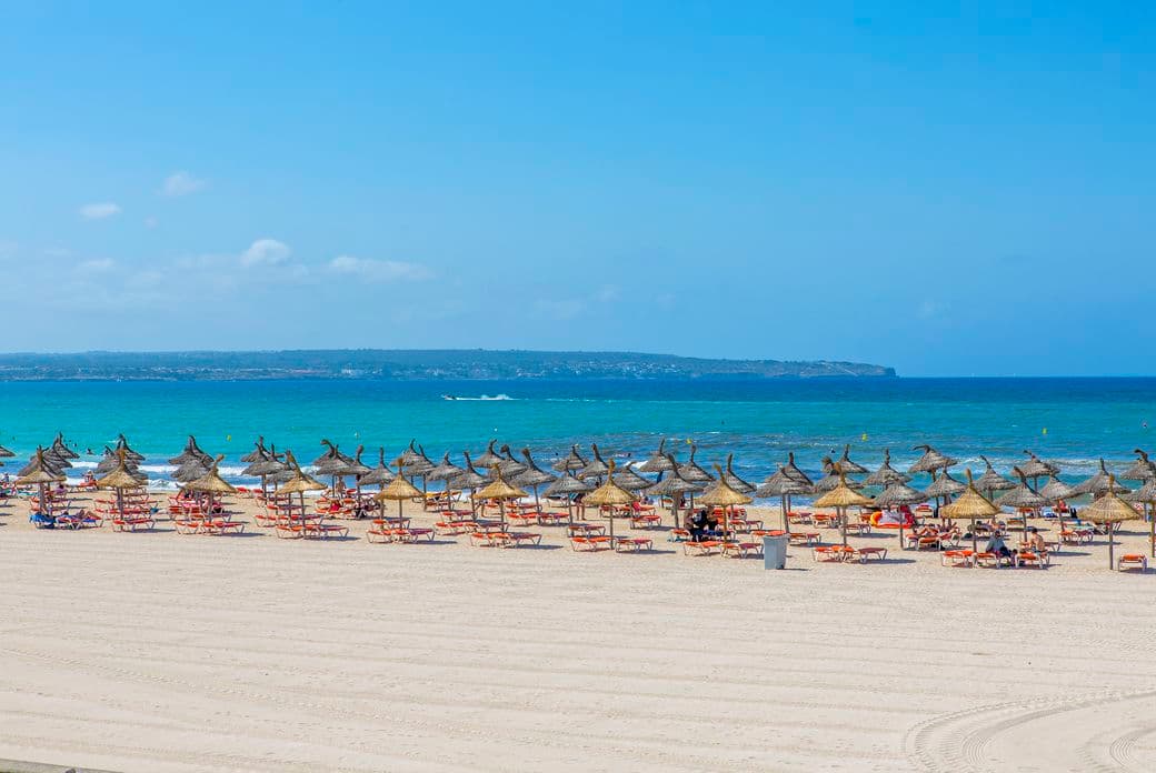 Beautiful view of Playa de Palma, with its golden sands, turquoise waters, and lively atmosphere, perfect for a day under the sun