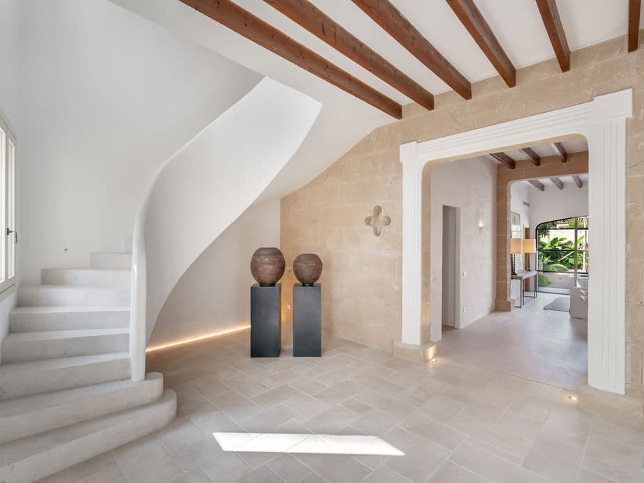 Interior of a beautifully renovated village house in Santanyí, featuring a sleek minimalist design with clean lines, neutral tones, and contemporary finishes