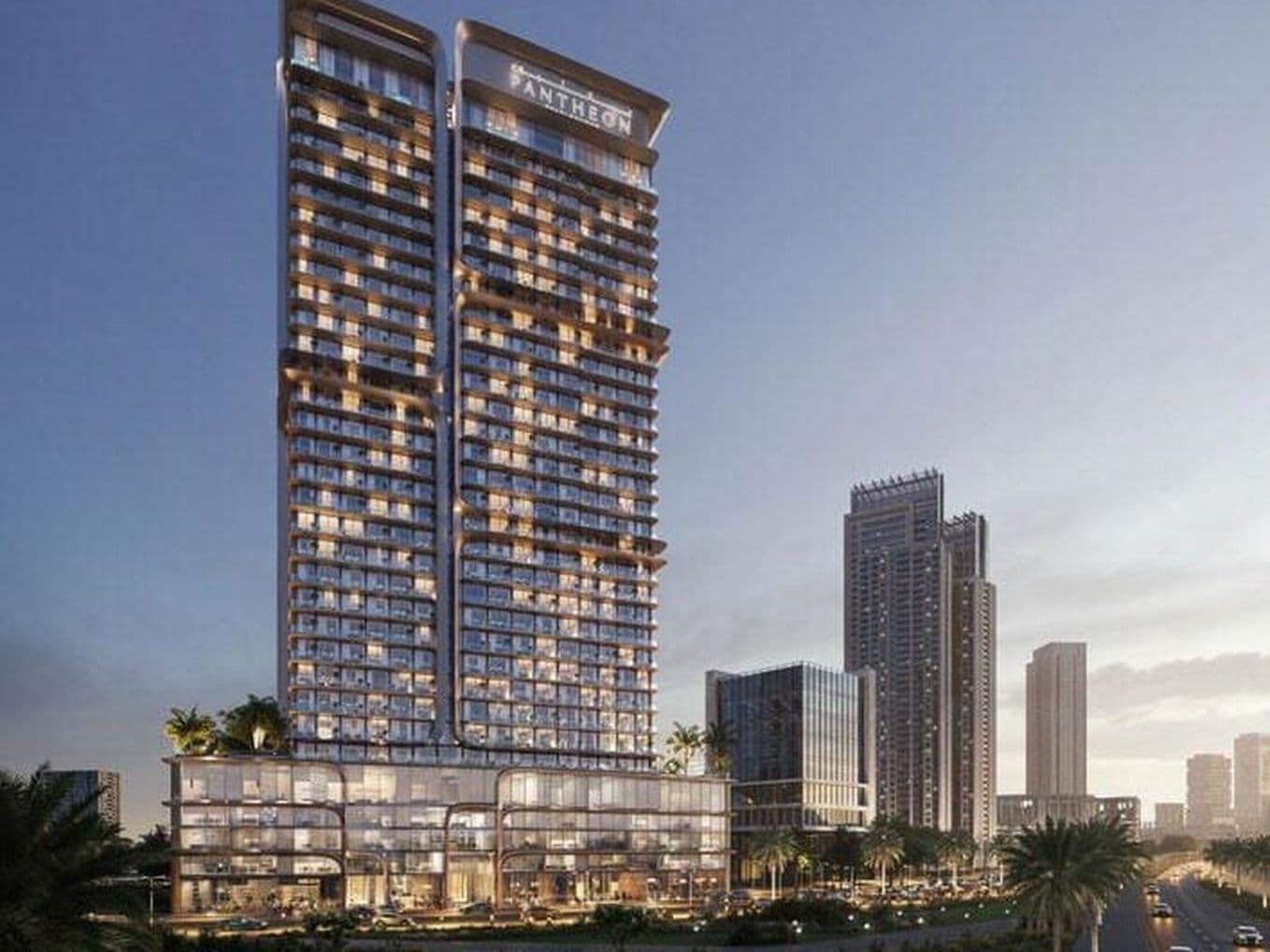 Exterior view of Voxa in Jumeirah Village Triangle showing the twin tower structure with glass façades, the Pantheon rooftop signage, and the multi level podium overlooking landscaped areas and surrounding high rise buildings.  If you want a shorter or even more minimal version for SEO, I can rewrite it.