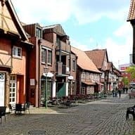 Cobblestone street with cafés and timber-framed homes in Harburg’s old town – attractive residential and mixed-use location
