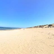 View of Playa Les Ortigues Torrevieja with its white sand and the sea on the horizon.