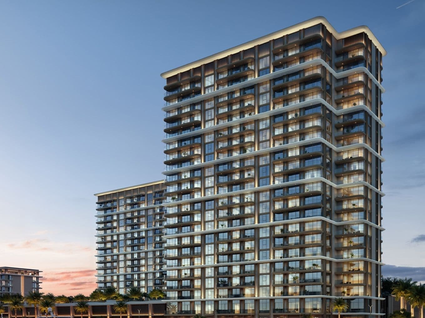 Sunset view of Baystar by Vida twin towers, with full glass façades, waterfront promenade, and yachts anchored in the foreground at Rashid Marina.