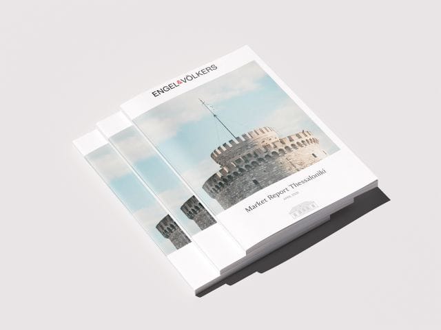 Stack of market reports titled "Market Report Thessaloniki" featuring an image of a historic tower on the cover.