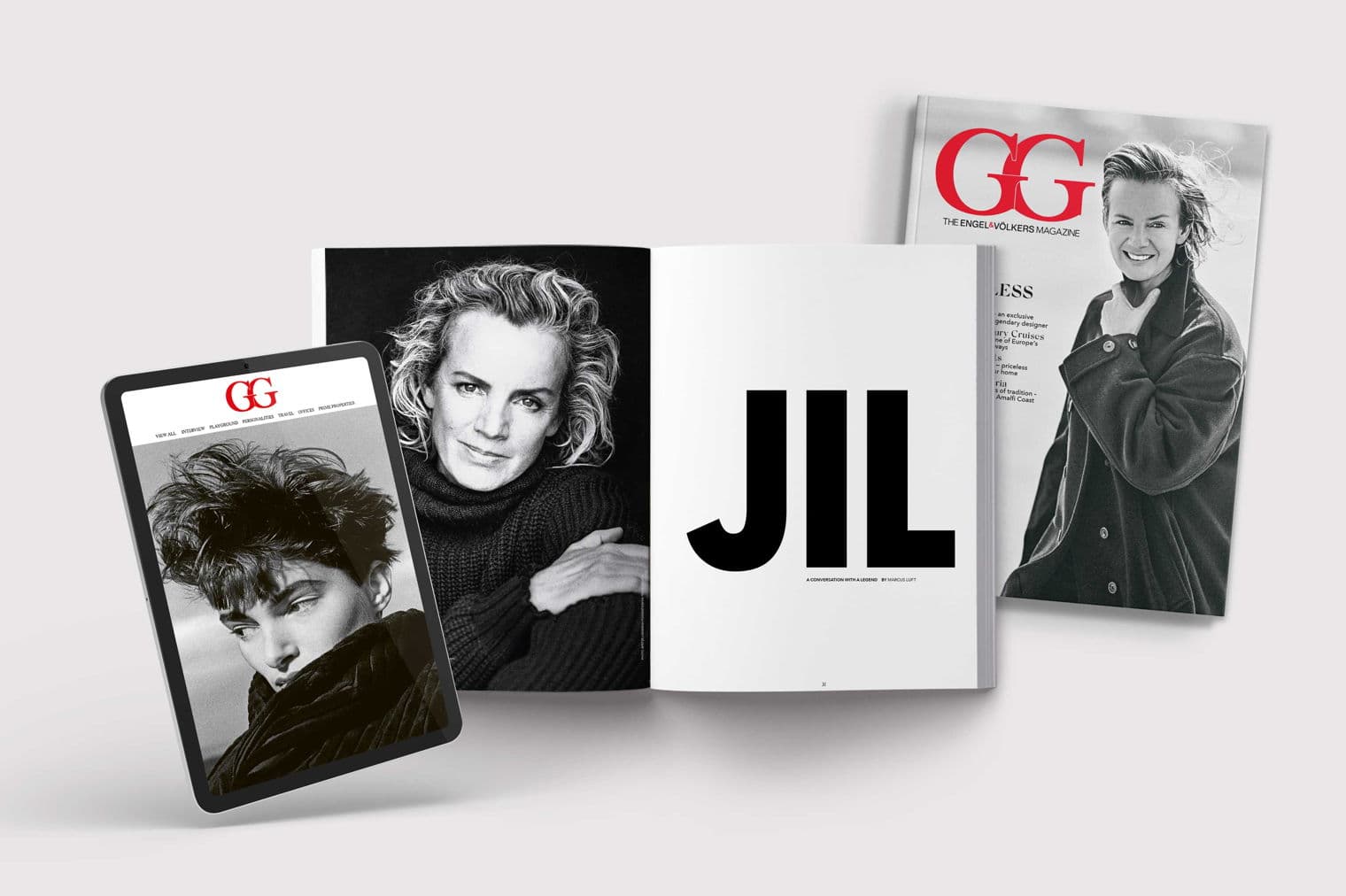 Engel & Völkers magazine featuring Jil Sander. A tablet, open magazine, and closed magazine are displayed. Black and white portrait.