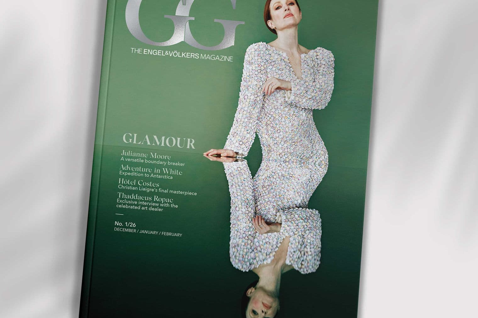 Magazine cover featuring Julianne Moore in a beaded dress, reflected in a glossy surface, against a green background.
