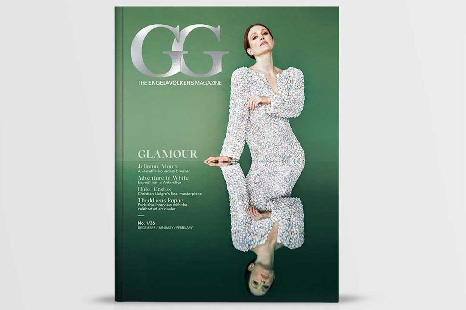 Magazine cover featuring a woman in a white dress against a green background, with a mirrored reflection below.