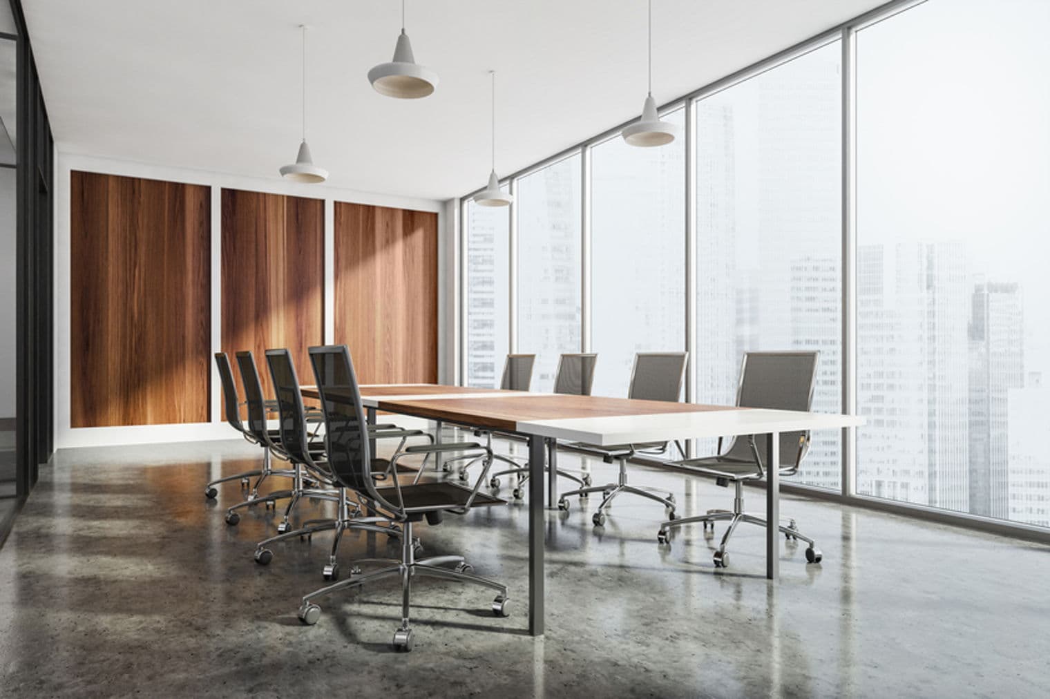 Conference room with a long table, mesh chairs, wood paneling, and large windows overlooking a city.