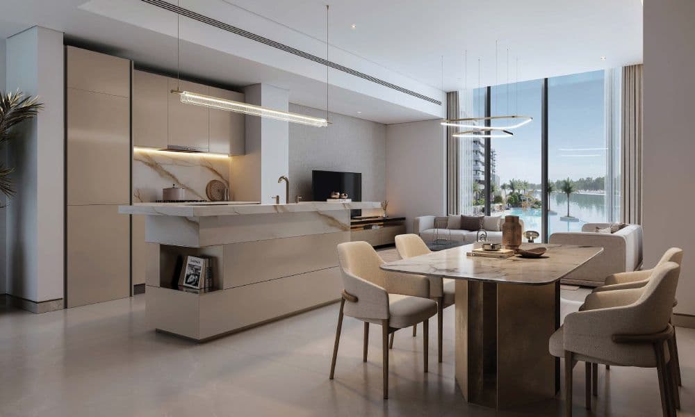 Modern open-plan living space with a minimalist kitchen, marble island, dining table, and view of a resort-style pool through large windows.